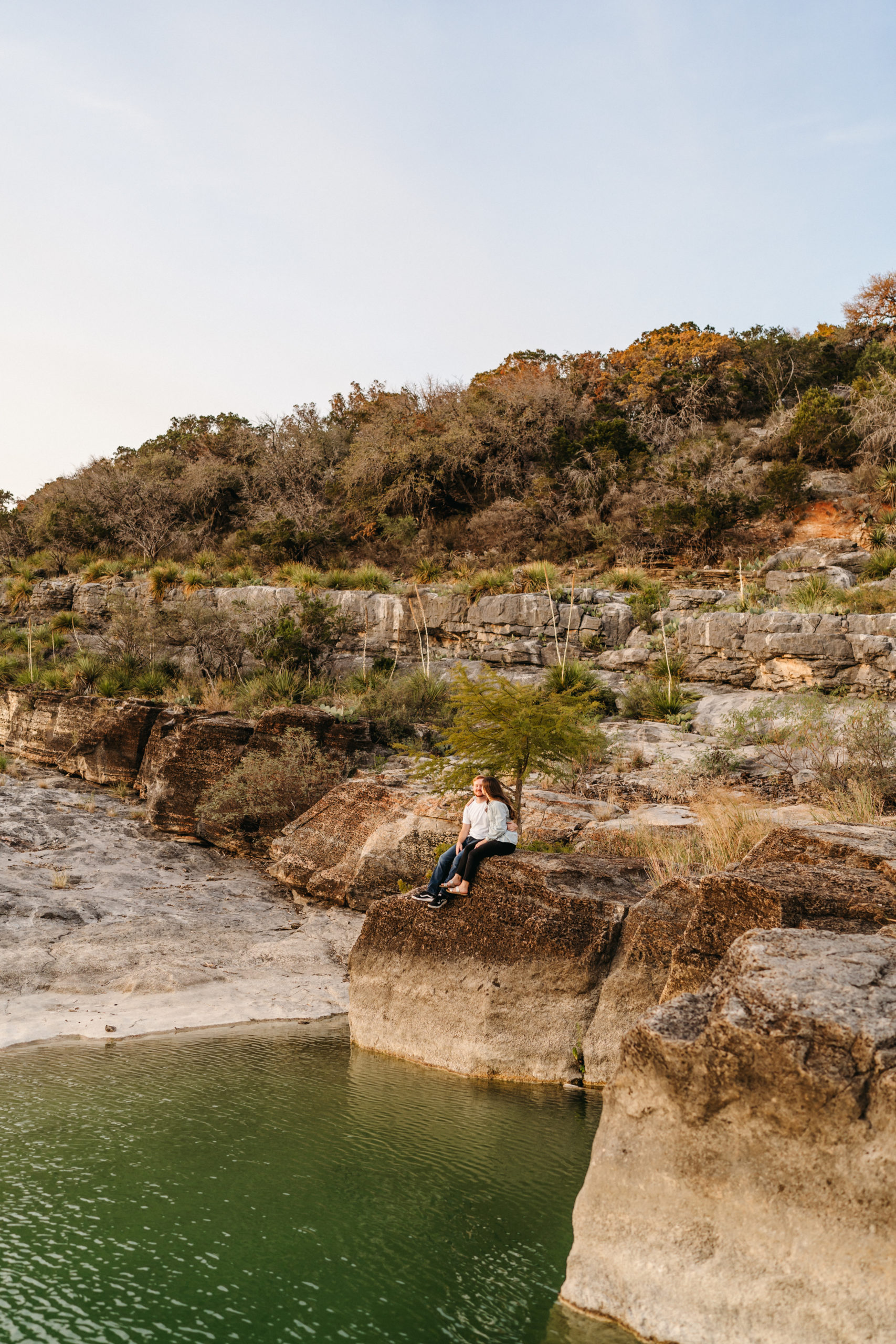 This timeless engagement session took place at the gorgeous Pedernales Falls State Park in Austin, Texas. We hiked the stunning Texas landscape to come across the infamous falls for their adventure engagement session. The couple’s outfit perfectly exuded their personality while also letting the scenery speak for itself. Angelina Loreta Photography created timeless engagement pictures for the Austin couple.