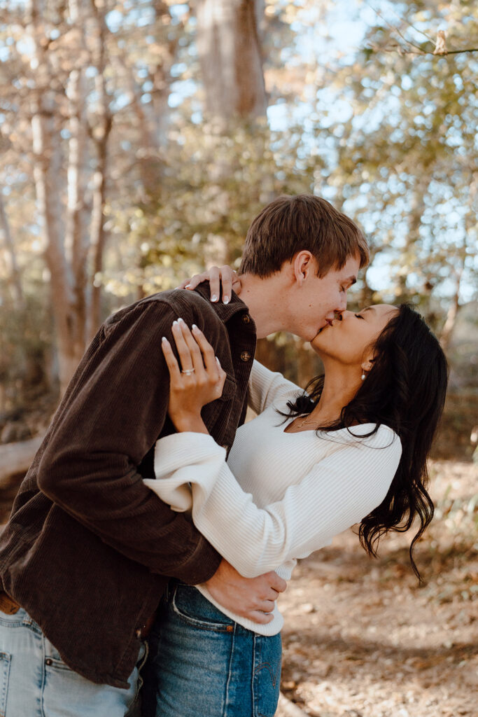 couple kissing fall engagement session poses and outfits