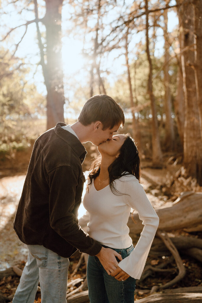 couple kissing fall engagement session poses and outfits