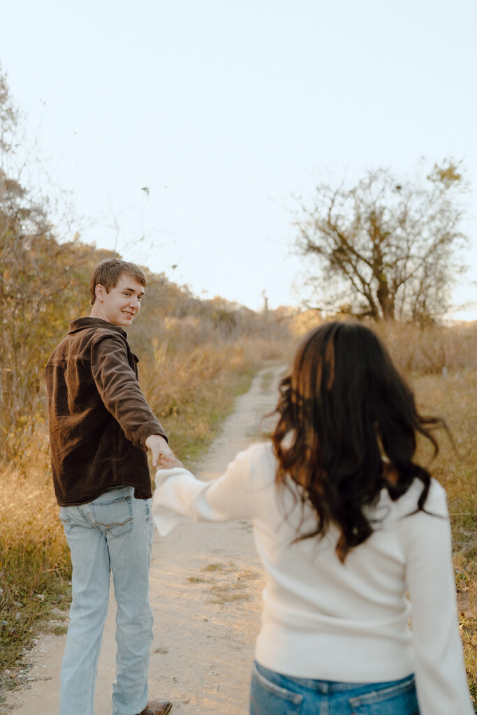 couple holding hands and walking during engagement session