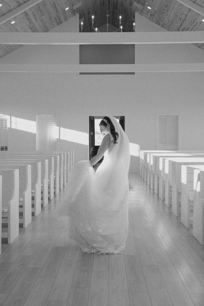 bride walking down the aisle portraits black and white