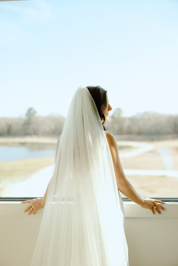 bride looking out the window at camp Hosea