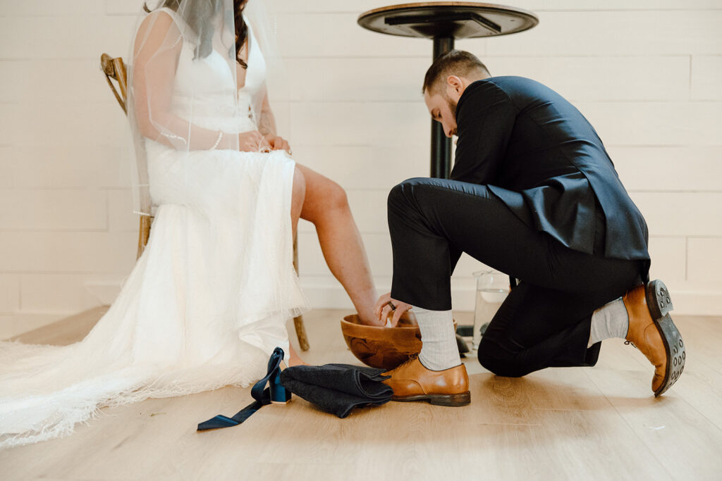 bride and groom washing feet during wedding ceremony