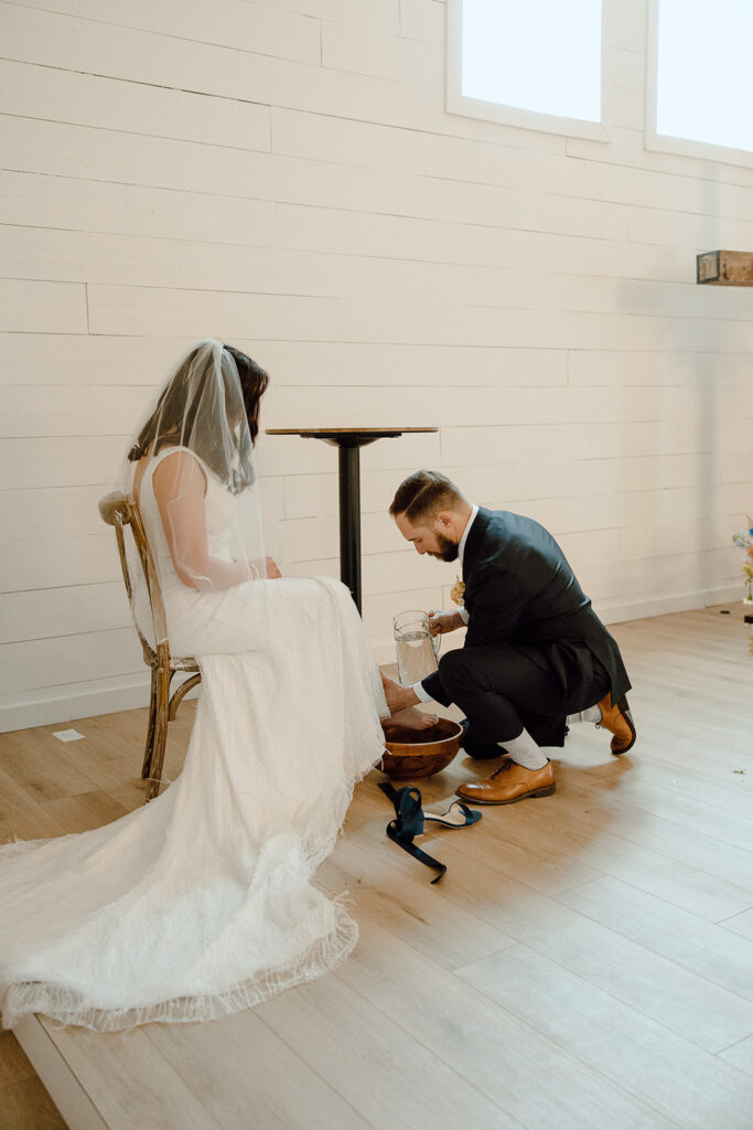 bride and groom washing feet during wedding ceremony