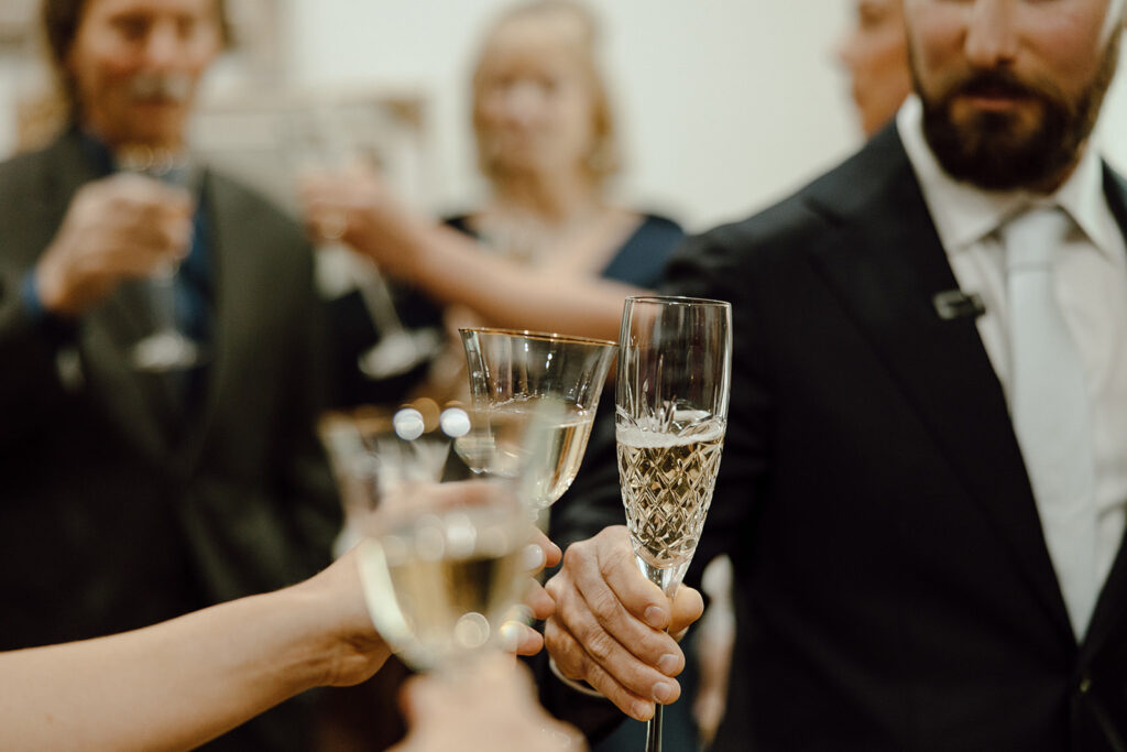 bride and groom celebrate marriage with family and champagne