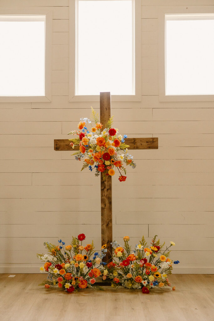 colorful spring wedding florals altar cross