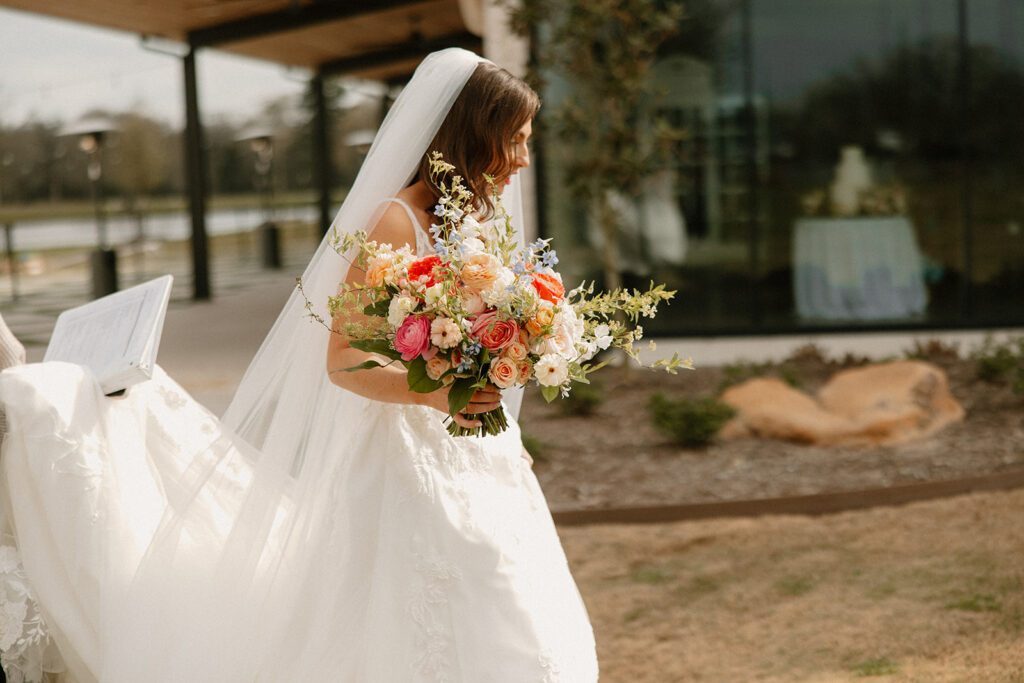 bride walking with bouquet in hand