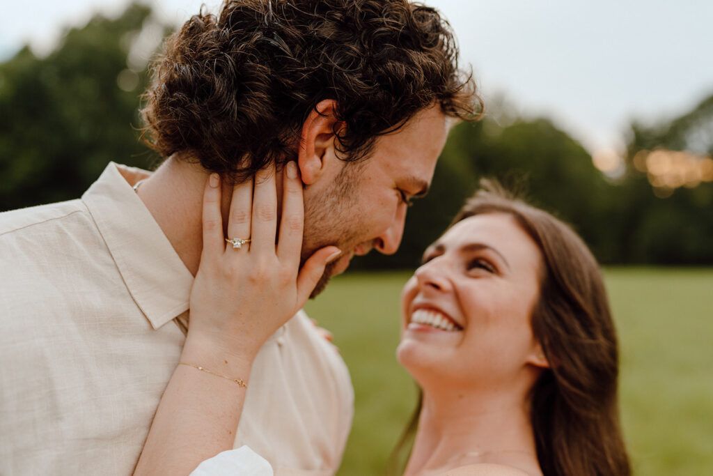 couple smiling engagement ring pictures