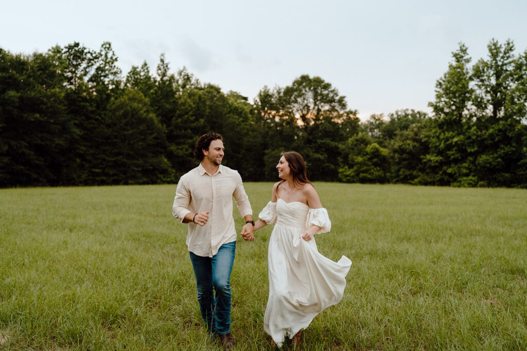 couple holding hands and running engagement session poses and prompts