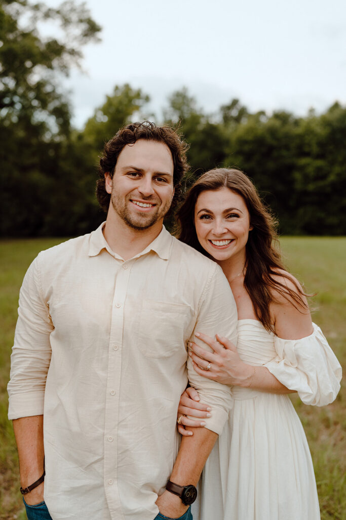 couple smiling at camera for texas engagement photos