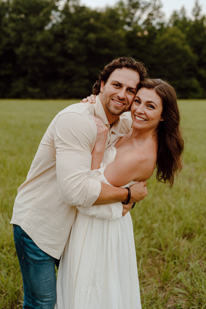 couple smiling at camera for texas engagement photos