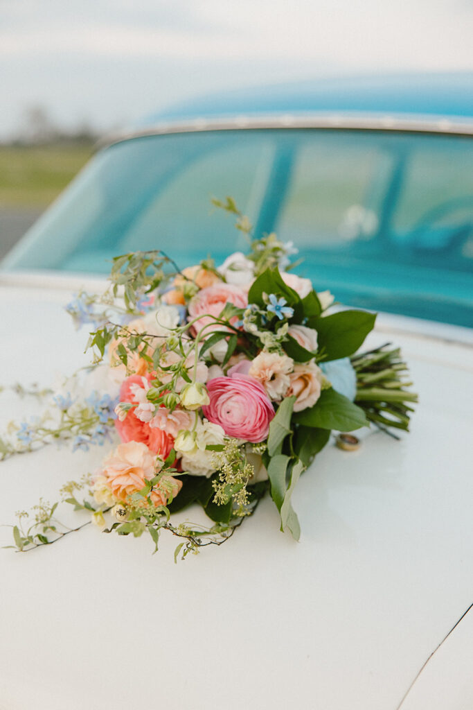 bright colorful bridal bouquet on vintage car
