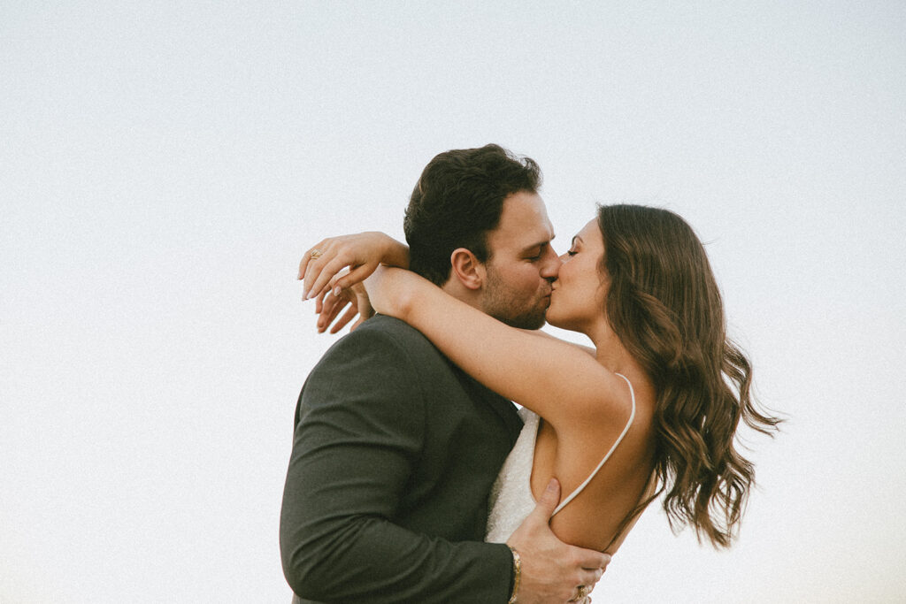 bride and groom kissing cinematic wedding photos