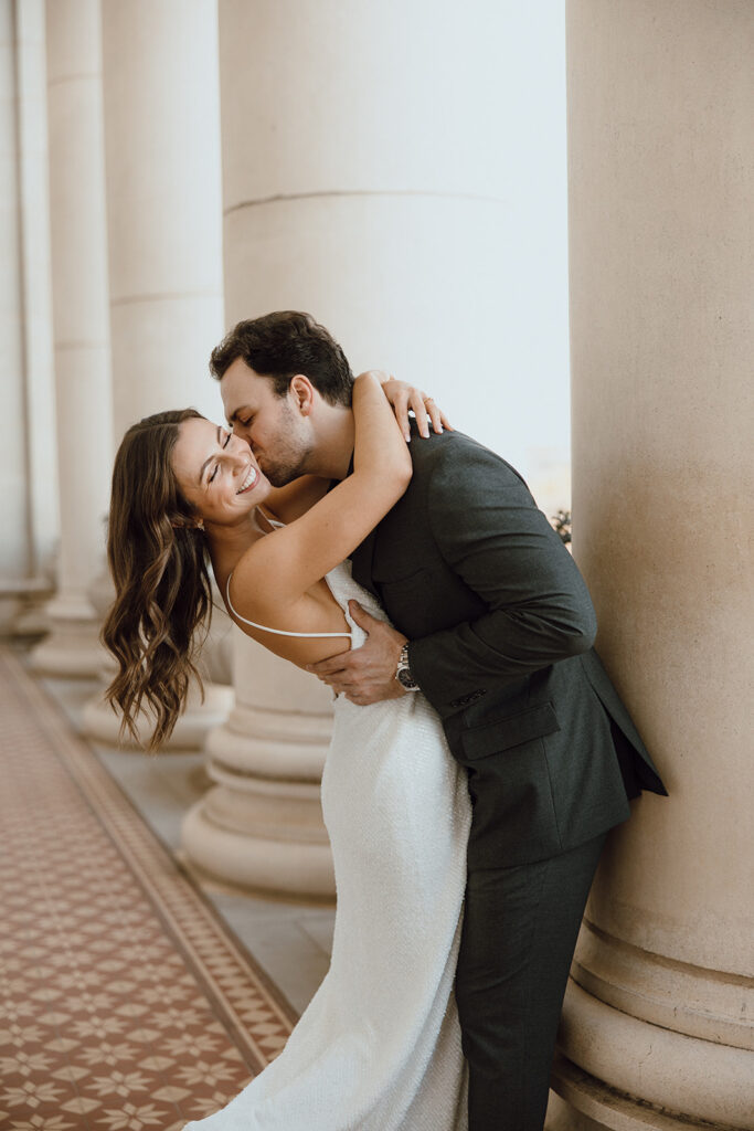 playful couple poses for bride and groom