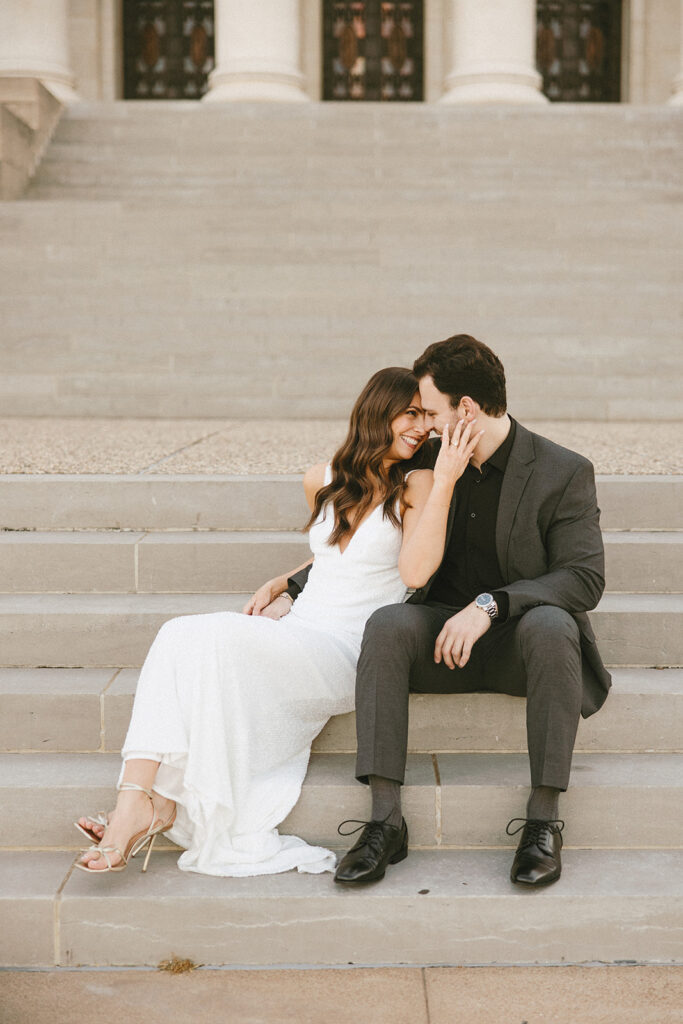 bride and groom smiling on steps