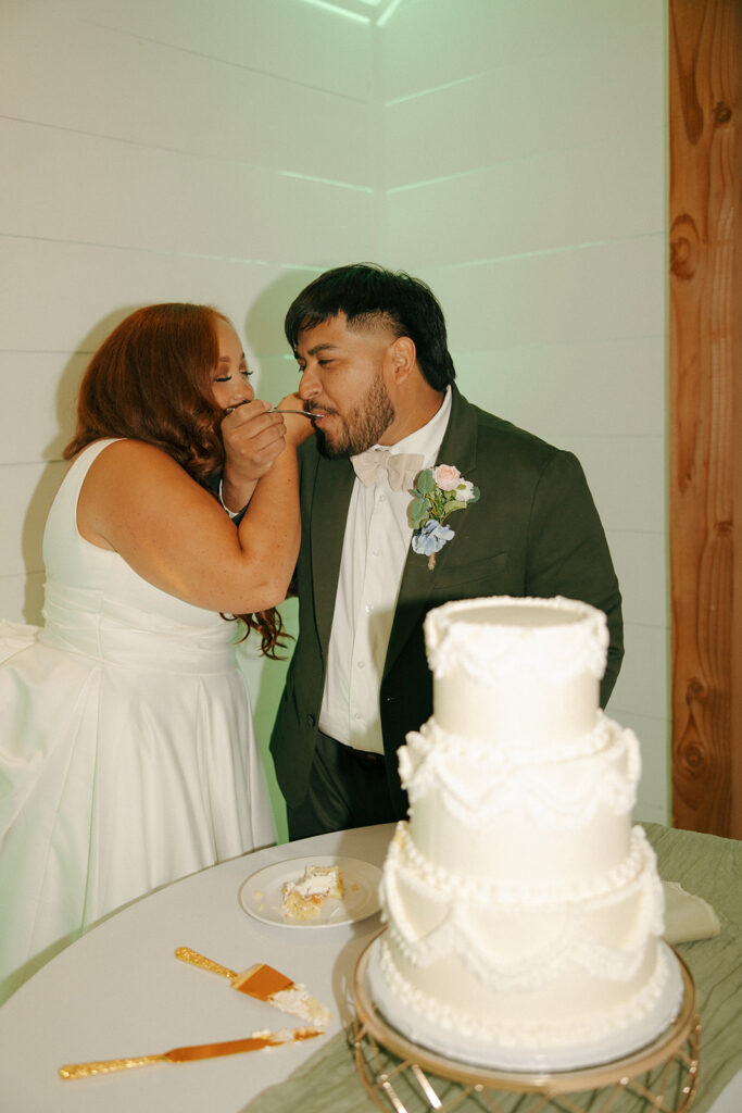 bride and groom eating wedding cake