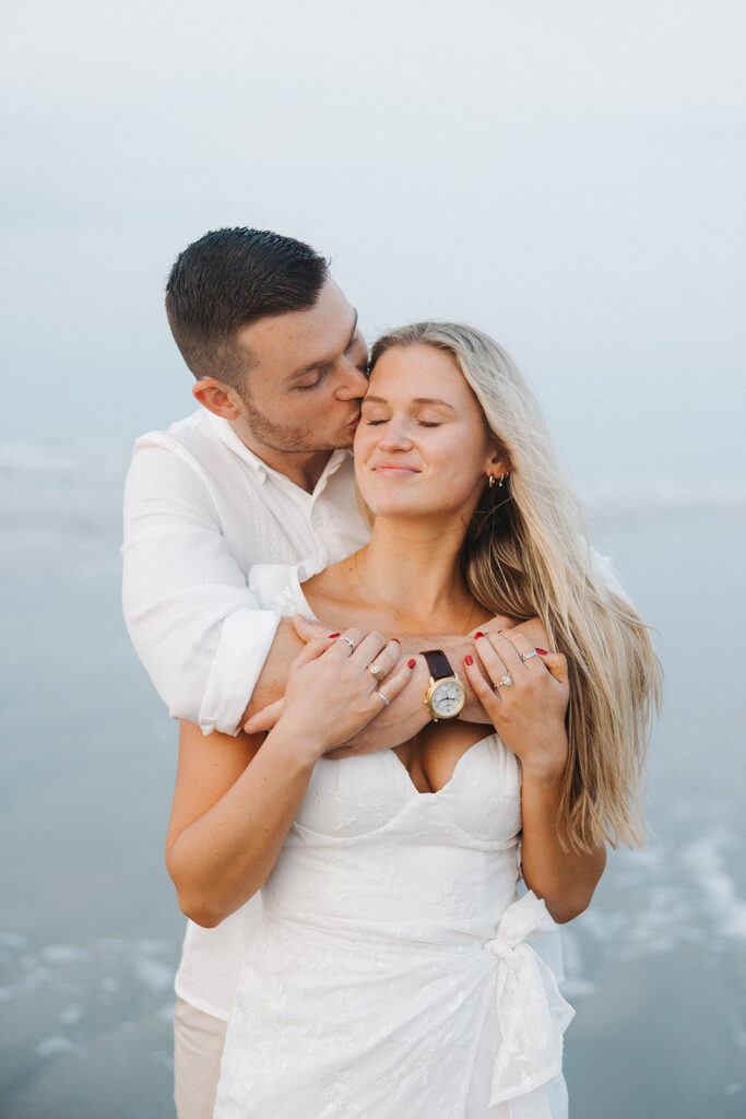 couple hugging and smiling for engagement photoshoot