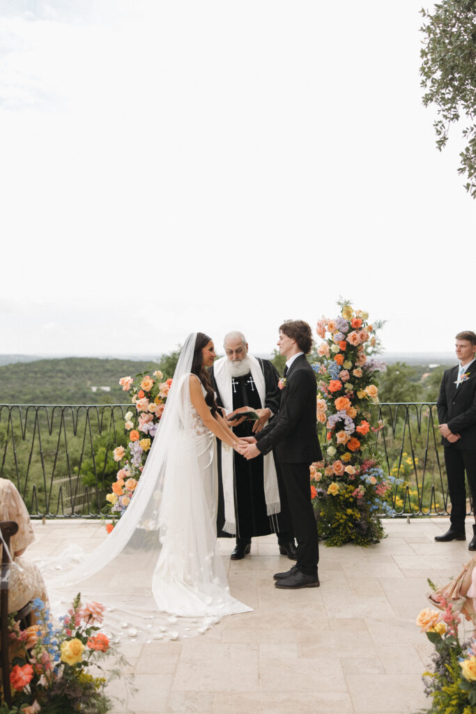 outdoor texas wedding ceremony with colorful flowers and decor