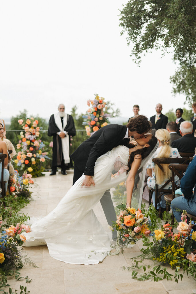 outdoor texas wedding ceremony with colorful flowers and decor