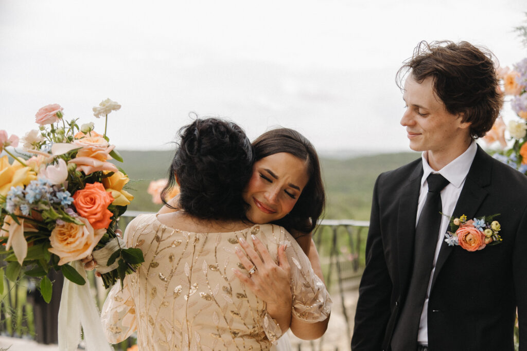 bride hugging mom after wedding ceremony