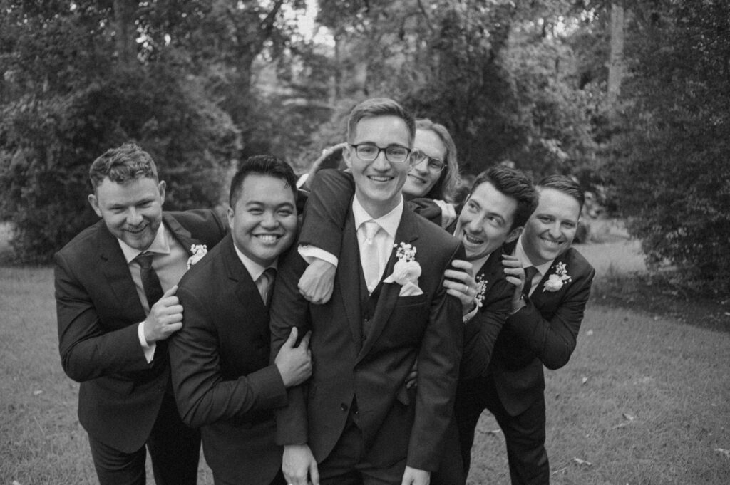 candid groomsmen poses magnolia texas photographer