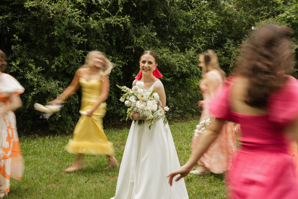 blurry bridal party photos with bride smiling in the middle