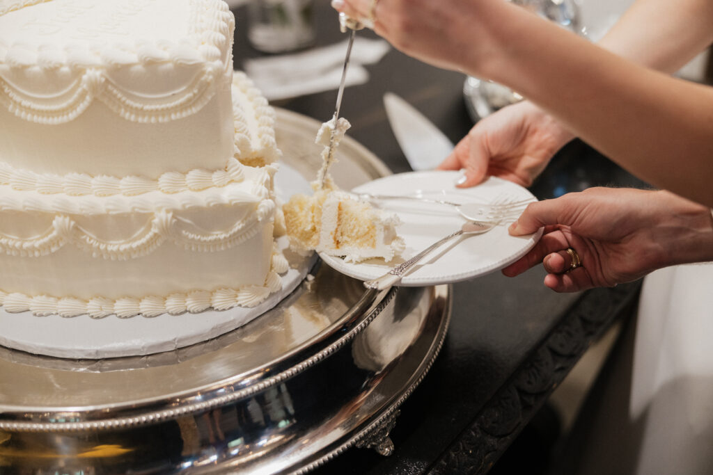 bride and groom cutting the cake at wedding reception