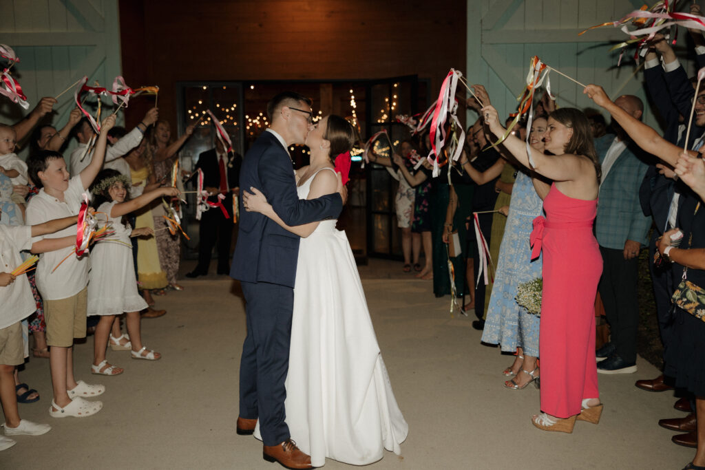 romantic wedding exit bride and groom kiss pose at the end