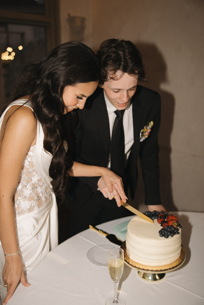 bride and groom cutting the cake