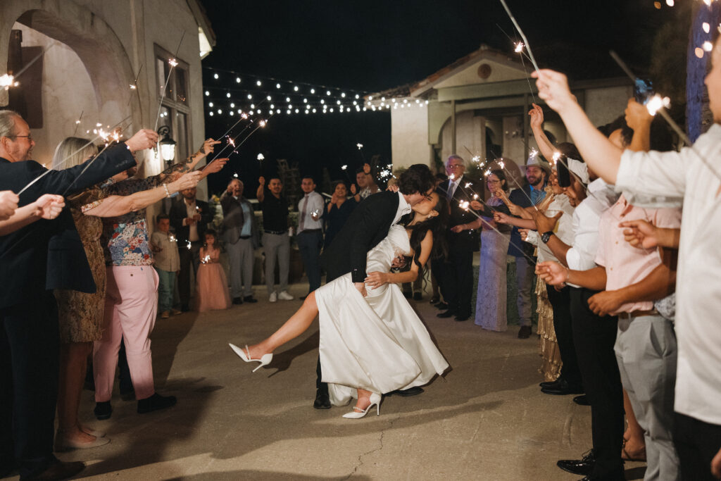 wedding sparkler exit dip kiss pose