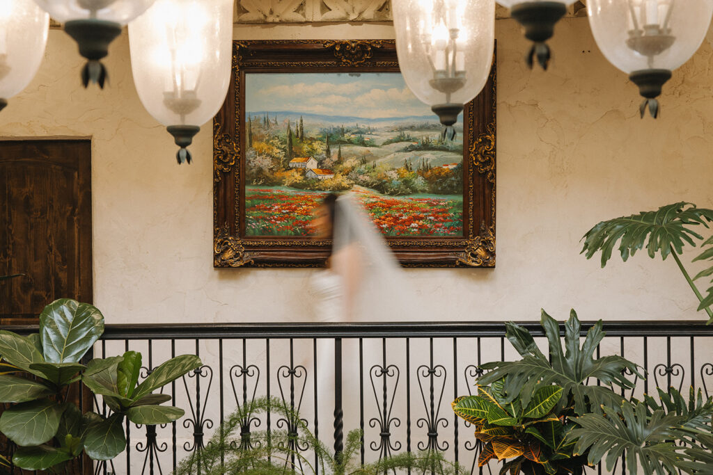 bride walking in front of painting blurry candid portraits