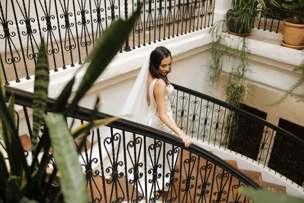 bride walking down staircase in texas wedding venue