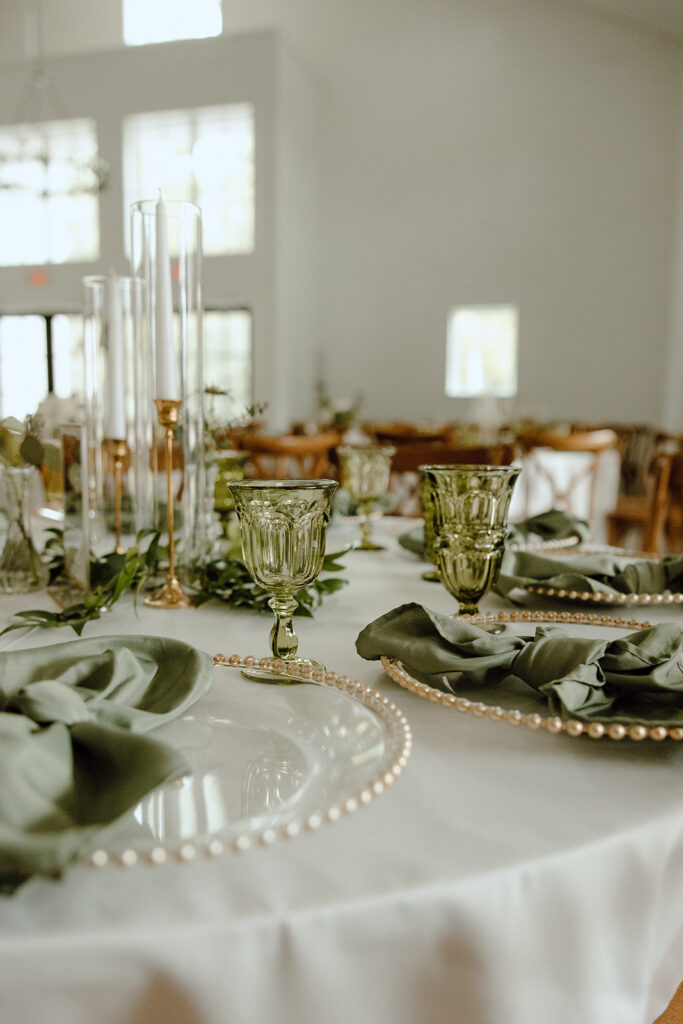 green and gold wedding decor on reception table