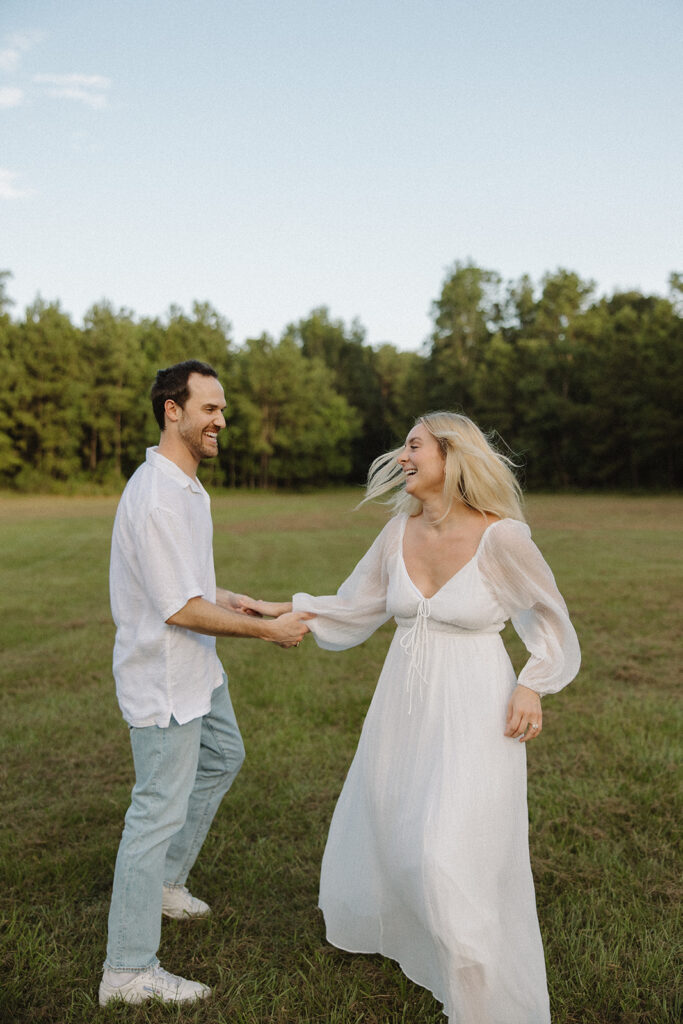 cinematic couples photoshoot running in a field