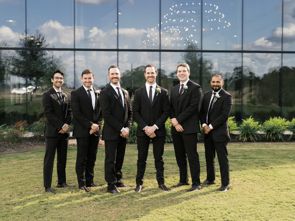 groomsmen standing in front of texas wedding venue