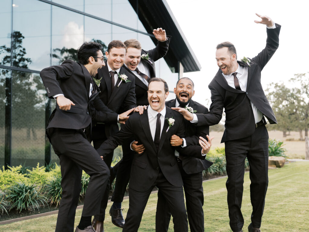 bridal party walking in front of texas wedding venue