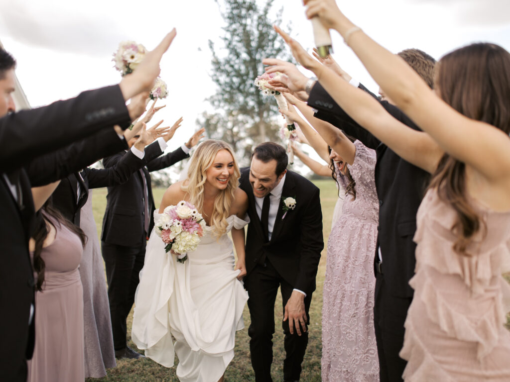 bridal party walking in front of texas wedding venue