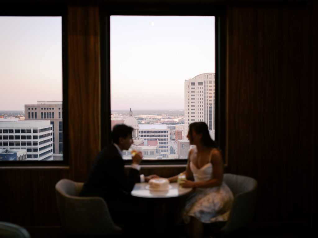 couple celebrating engagement with cake and drinks