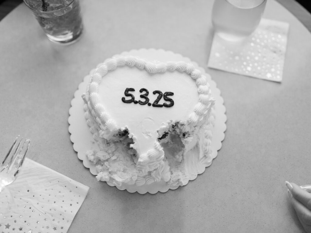 couple celebrating engagement with cake and drinks