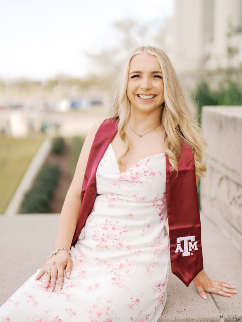 college senior smiling in her cap and gown