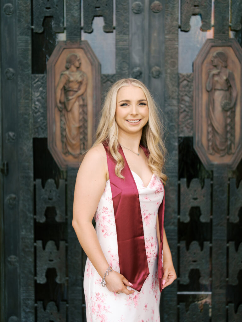 college senior smiling in her cap and gown
