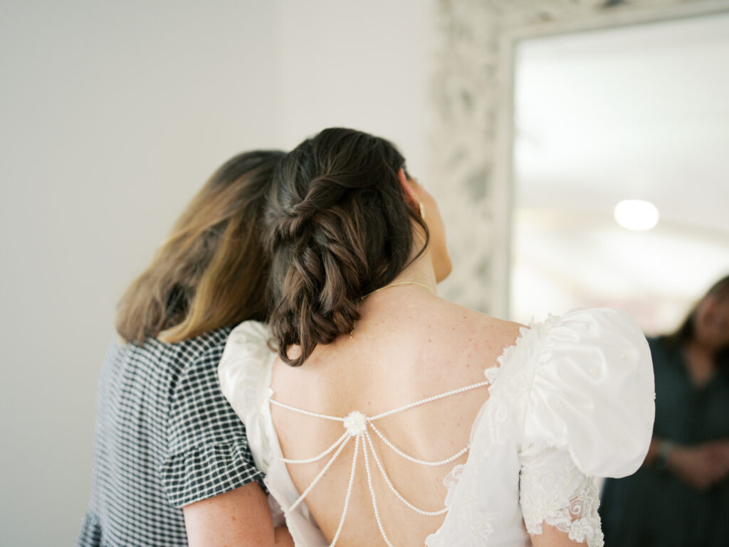 bride and mom getting ready in the bridal suite
