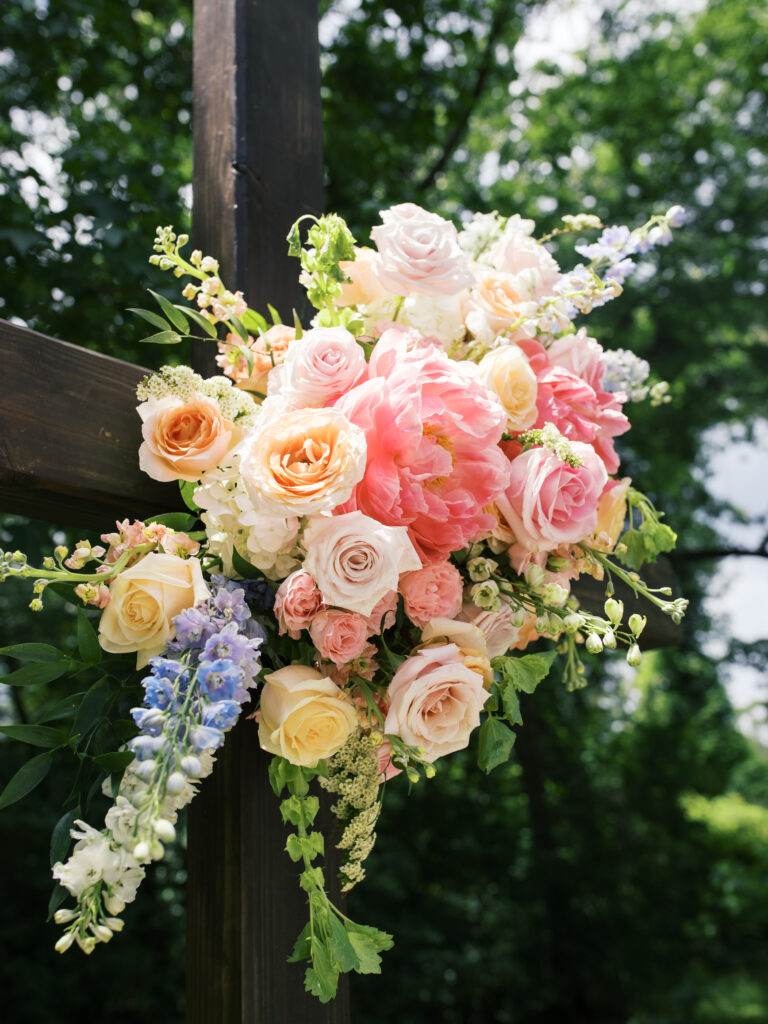 colorful vintage wedding flowers on the cross altar at The Meekermark