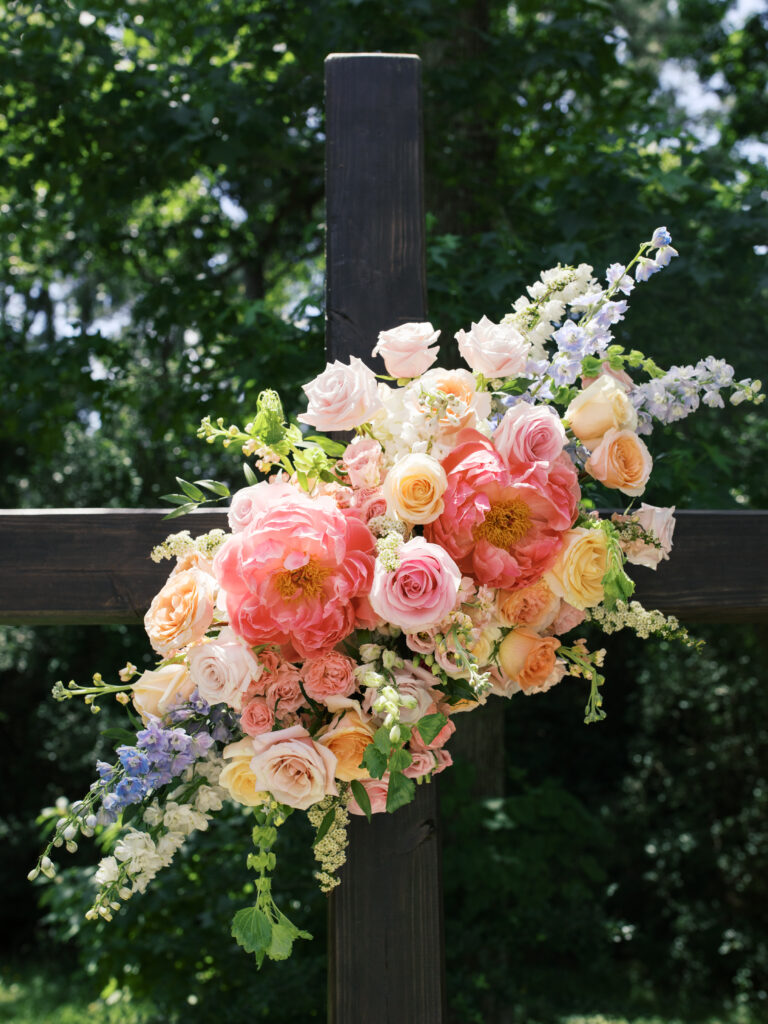 colorful vintage wedding flowers on the cross altar at The Meekermark