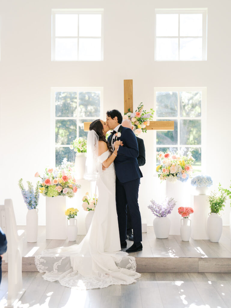 indoor wedding ceremony in texas with bright florals