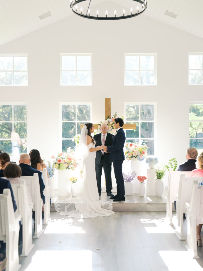 indoor wedding ceremony in texas with bright florals