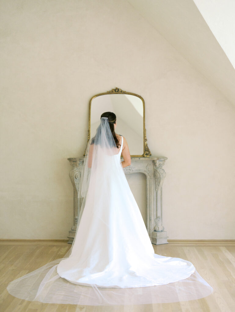 bride looking at herself in the mirror