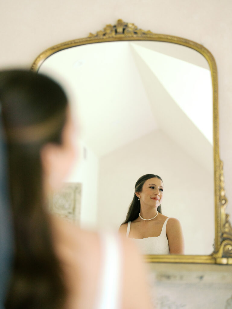 bride looking at herself in the mirror