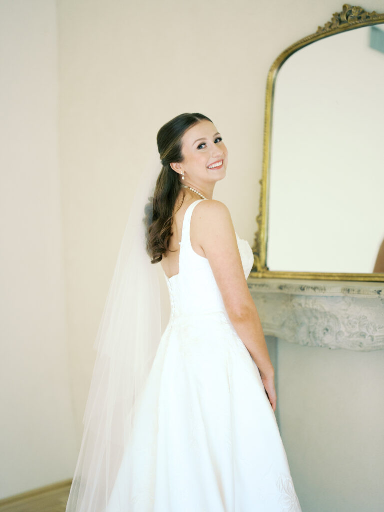 bride smiling at the camera for bridal photoshoot