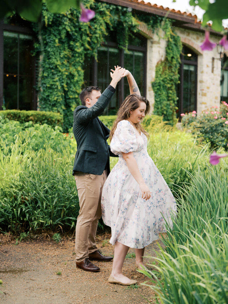 couple celebrating surprise proposal in the rain